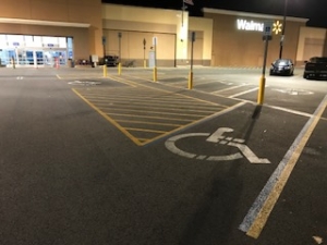 Before: Handicap parking space with worn out and faded painting and stripes